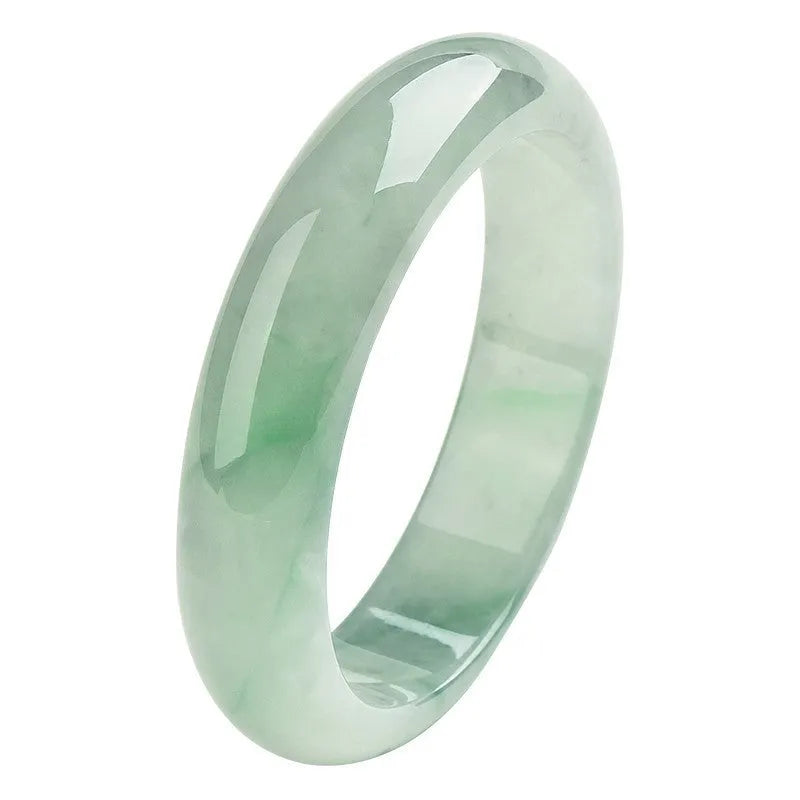 Light green jade bracelet on wrist showing natural stone texture and colour