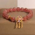 Women's strawberry quartz bracelet with dream catcher pendant and four-leaf clover charm in natural pink crystal