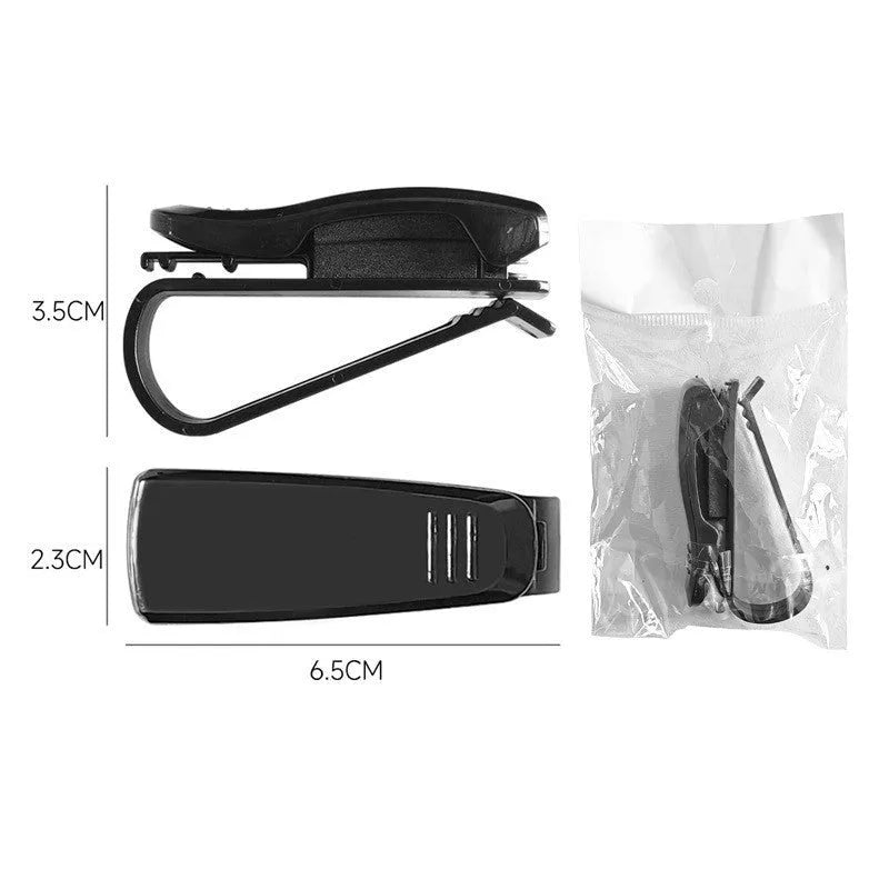 Black plastic multifunctional clip for car sun visors to hold tickets, IDs, or glasses.