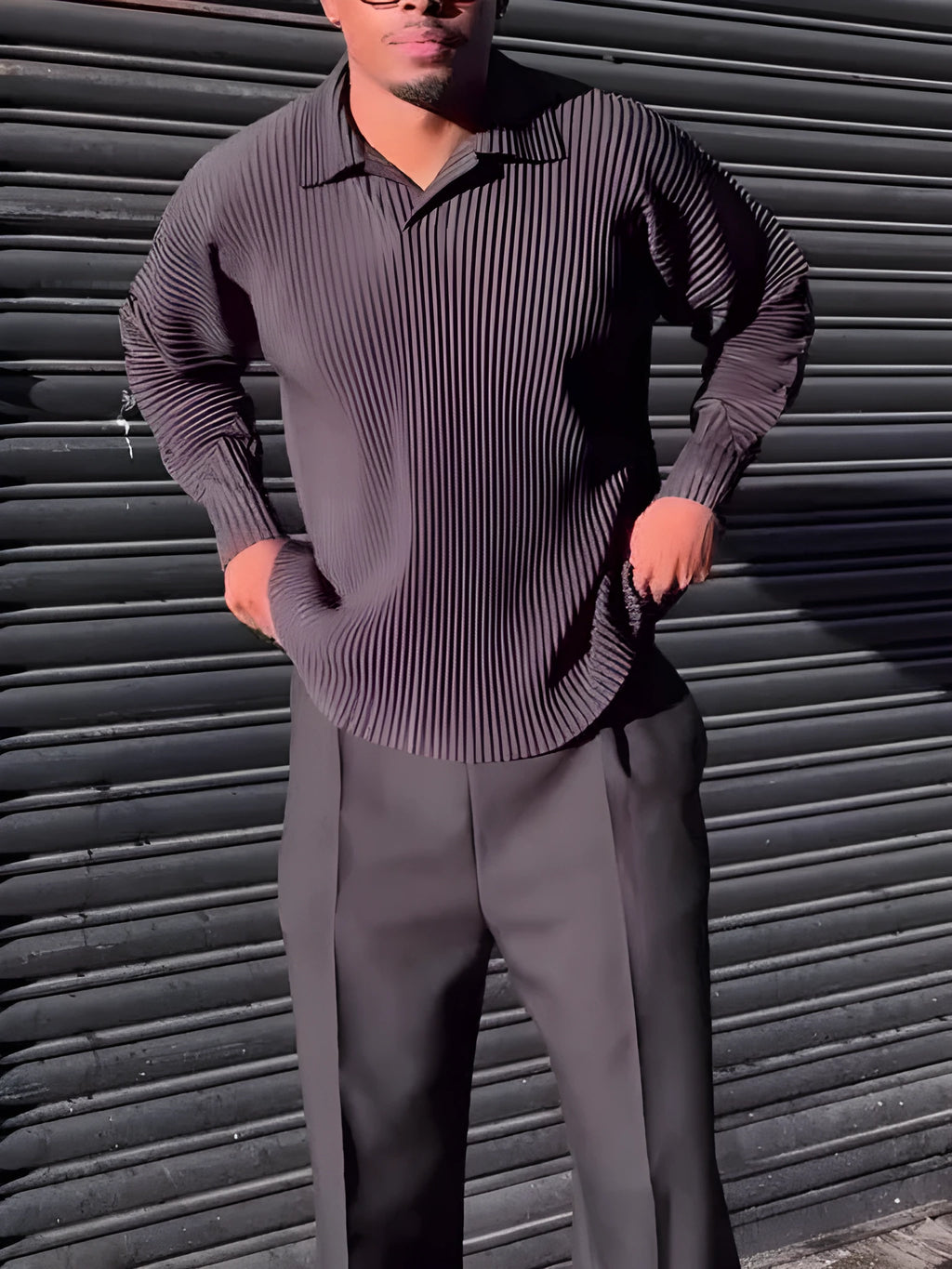 Man wearing a black pleated long-sleeved casual polyester top.