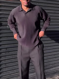 Man wearing a black pleated long-sleeved casual polyester top.