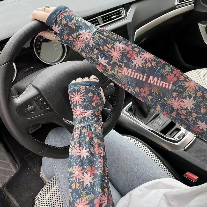 A pair of lightweight ice silk sun protection sleeve gloves in a floral print pattern, covering from wrist to elbow.
