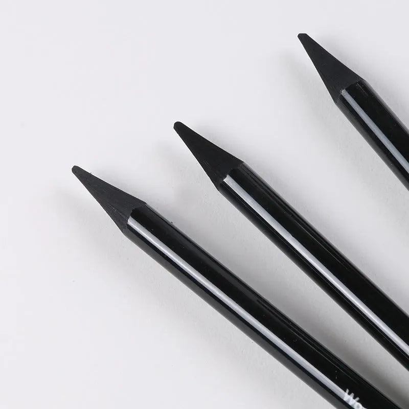 Set of six graphite and three carbonised art pencils in suction card packaging.