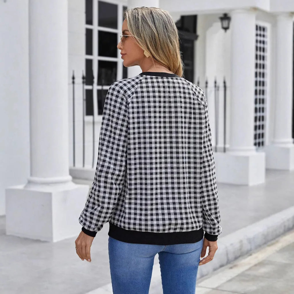 Black long sleeve pullover sweater with a classic plaid stripe print pattern.