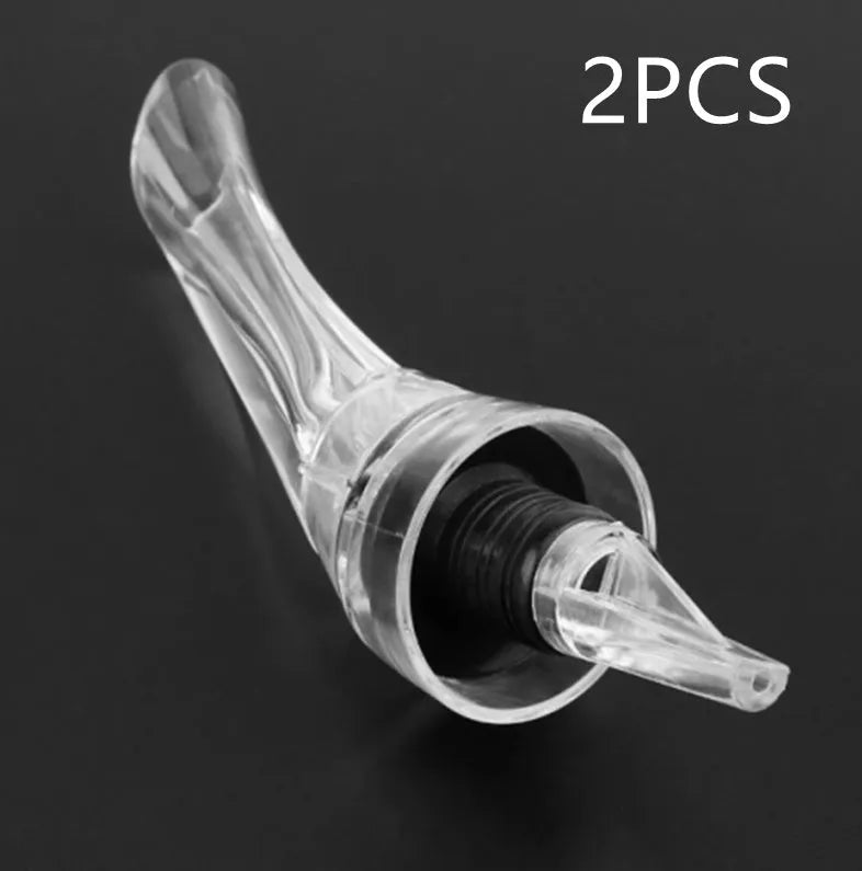 Clear acrylic wine aerator with stainless steel filter, 16 cm long.