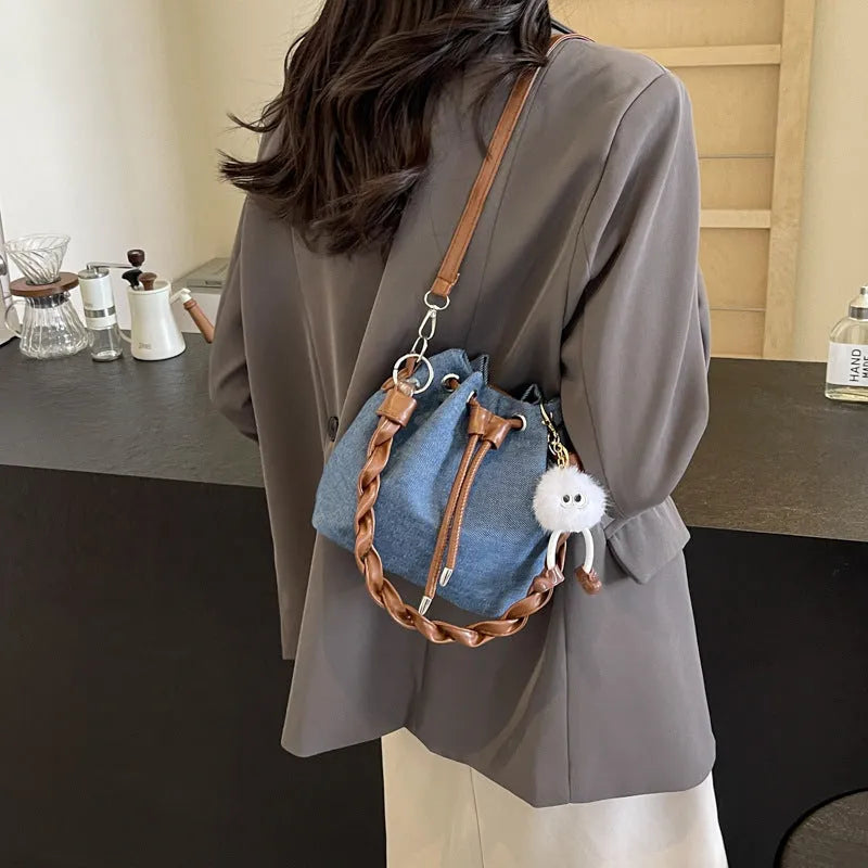 Blue one-shoulder cross body bucket bag with synthetic leather lining and sandwich pocket