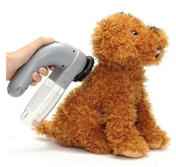 Grey portable electric pet hair removal vacuum with soft rubber grooming head.