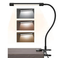 Black and white USB-powered LED desk lamp with flexible 26 cm gooseneck neck on a desk.