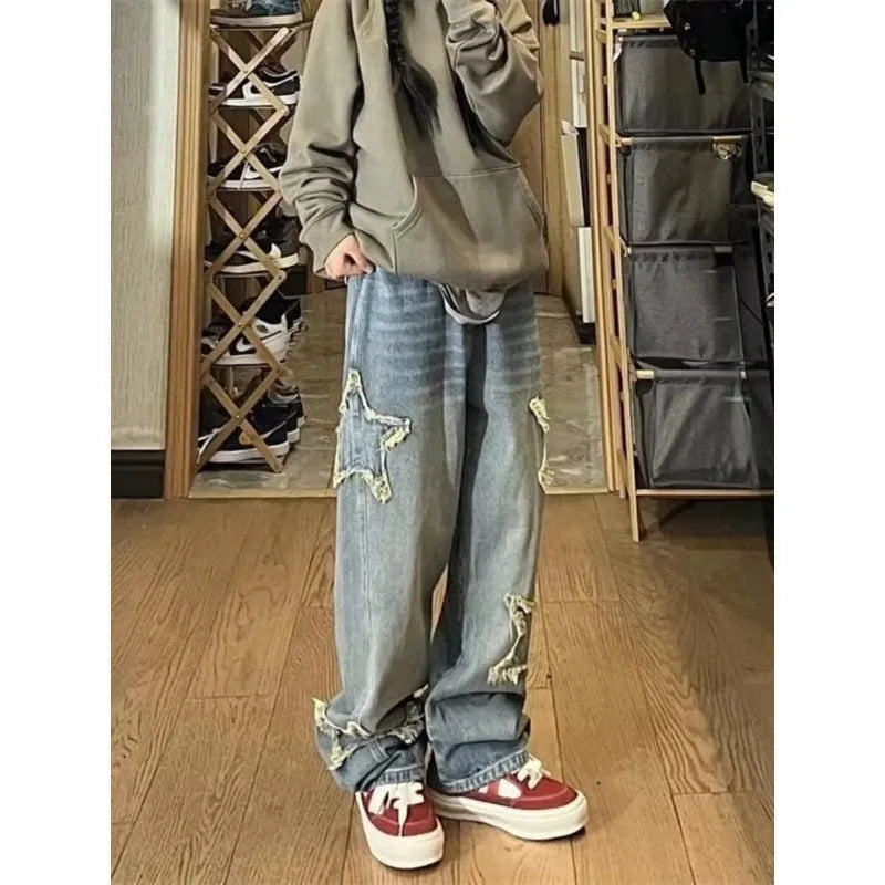 Blue women's high waist wide-leg denim jeans on a hanger, showing the straight leg cut.