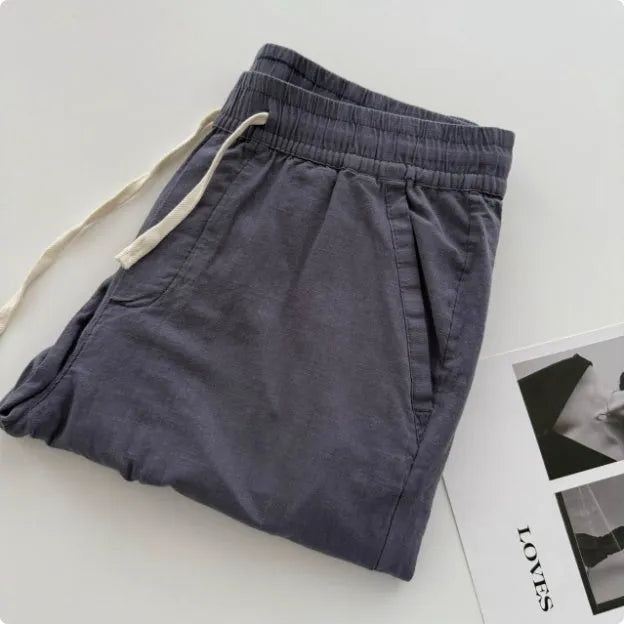 Men's loose fit straight leg casual trousers in beige with a drawstring waistband.