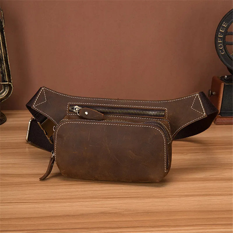 Brown top layer cowhide men's waist bag with pull cord closure, shown with phone compartment open.