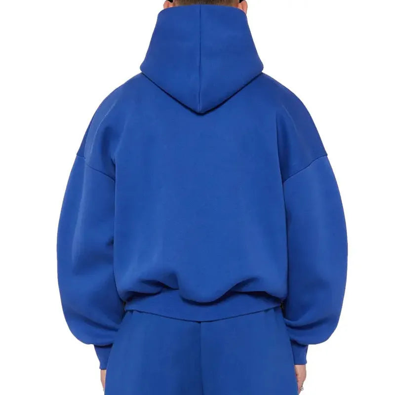 A man's solid-colour fleece-lined cotton hoodie with a wool interior, shown in a casual setting.