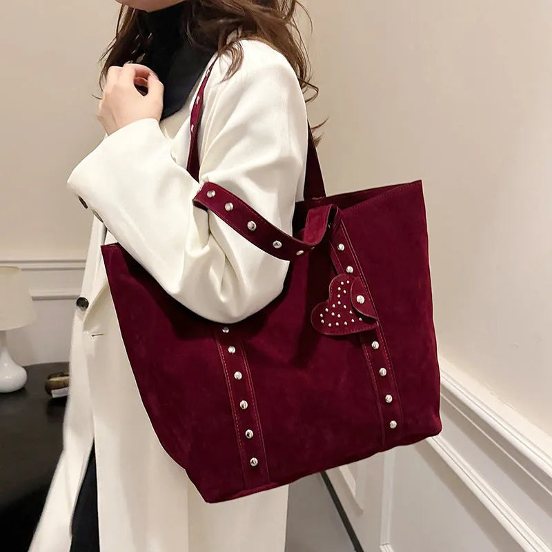 Black PU leather horizontal tote bag with double shoulder straps, showing outer sandwich pocket.
