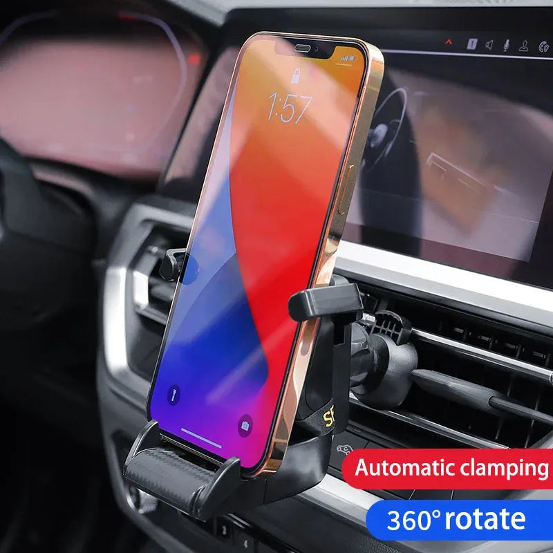 Gold coloured car air vent mobile phone holder with 360-degree rotating head mounted on a car dashboard vent.