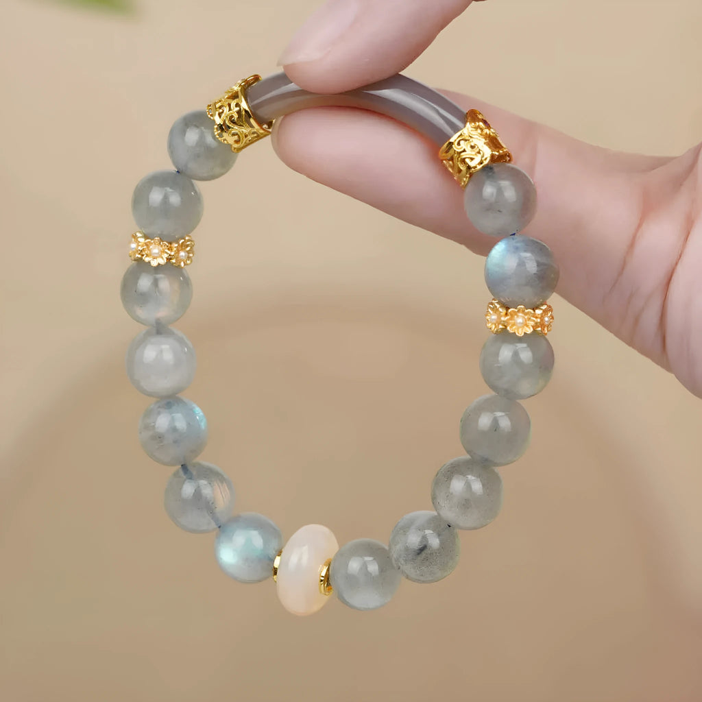 Grey moonstone women's bracelet with 8mm round beads on a wrist.