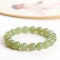 Polished Hetian jade ball bracelet on wrist, showing ice-like clear beads in available 4mm, 6mm, 8mm, and 10mm sizes.
