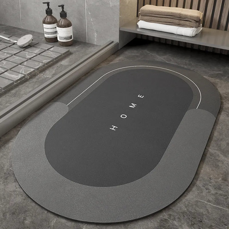 Machine-woven blended bathroom floor mat in blue, shown in an oval shape on a tiled floor.