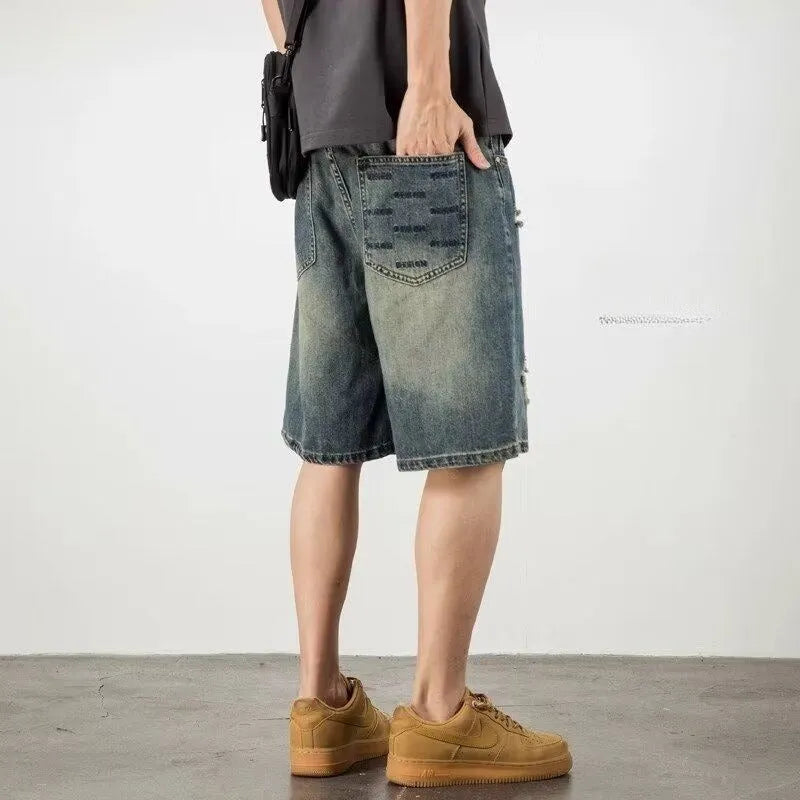 Blue retro loose-fit men's denim shorts with distressed holes and a straight-leg cut