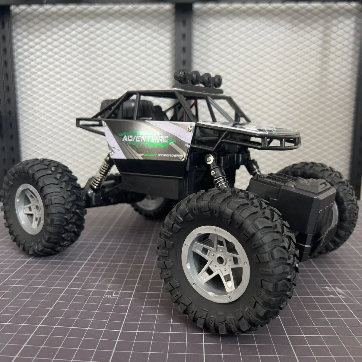 Children's rechargeable four-wheel drive remote control off-road car in fire blue colour with handle controller