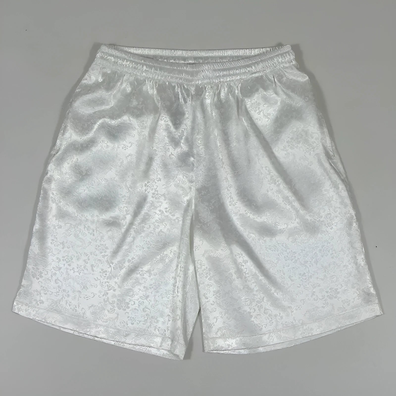 Man wearing traditional black Tang suit style Tai Chi shorts with an elastic drawstring waistband.