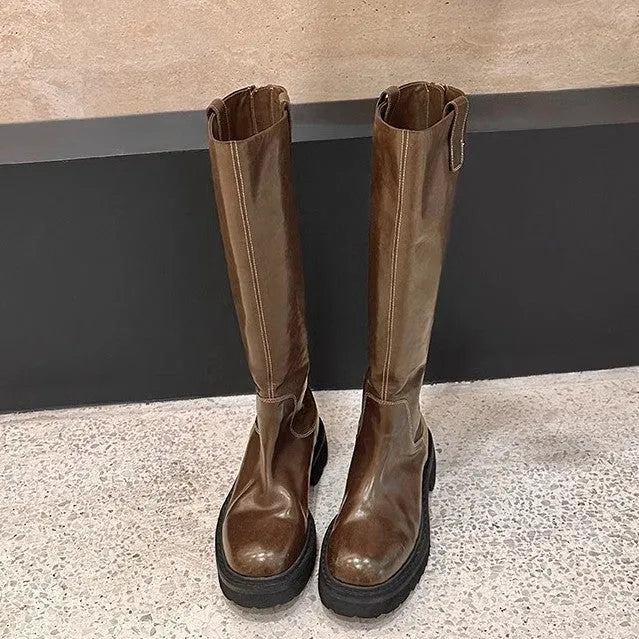 Black chunky heel knight boots with round toe and high shaft, showing the back zip detail.