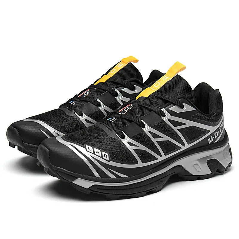 Pair of low-top hiking shoes in artificial leather with a mesh lining and rubber sole.