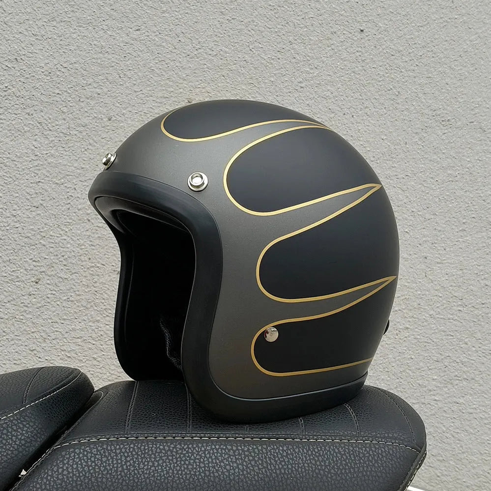 Retro-style open-face motorcycle helmet in fibreglass, shown in a choice of colours including Cement Grey and Matte Black Flower.