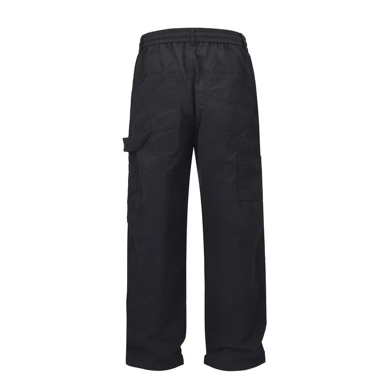 Black paratrooper pants with baggy fit and drawstring waist adjustment