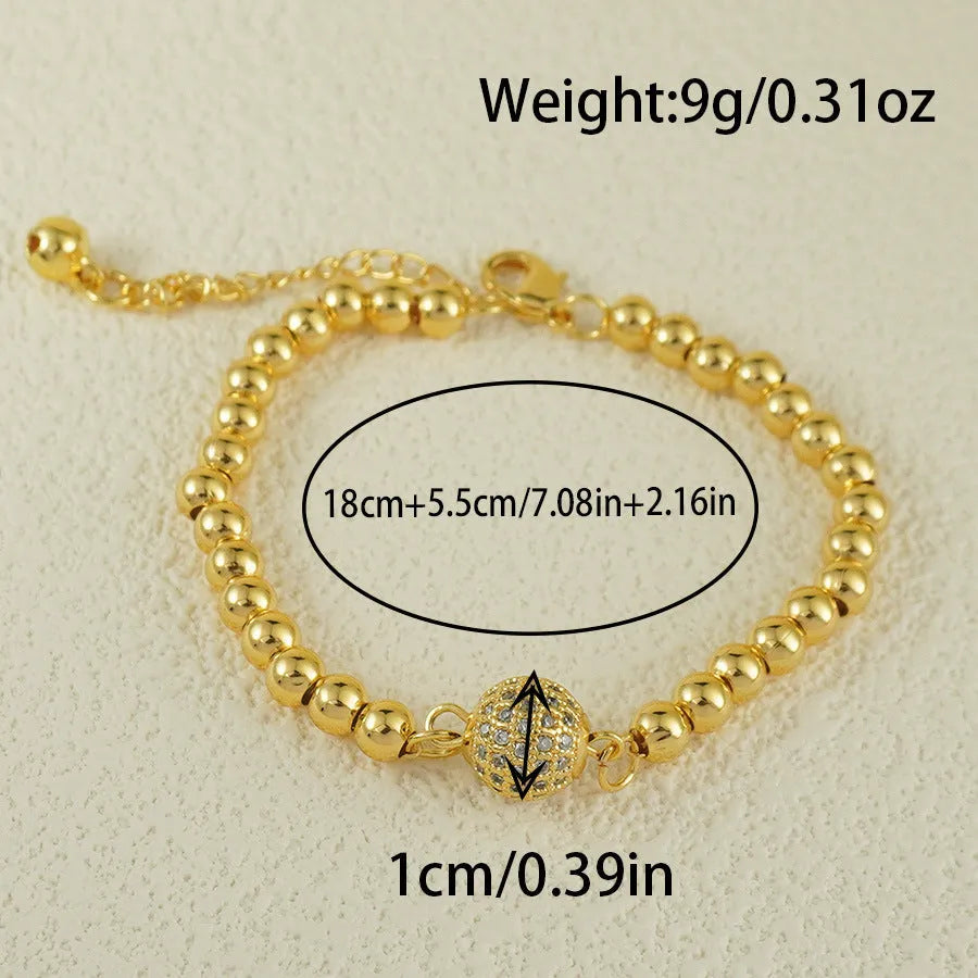 Close-up of a women's copper bracelet with a heart shape design and round zircon stone accents in an Arabic style.