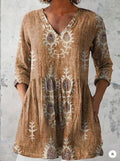Women's loose fit printed dress with wide waist and three-quarter length sleeves.