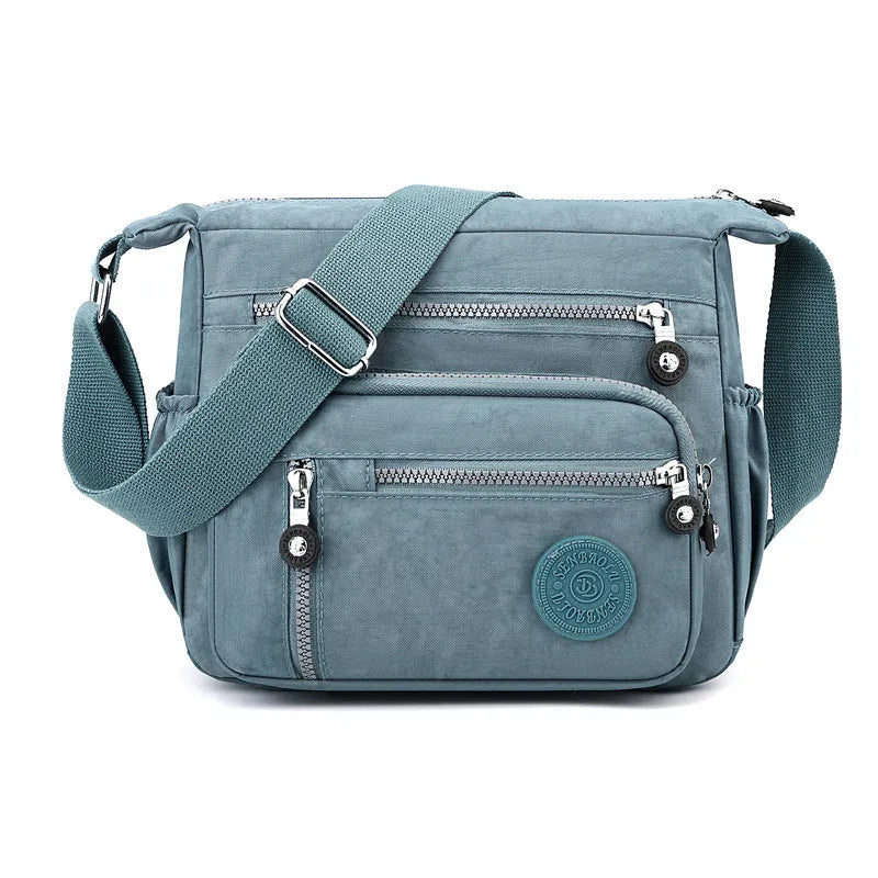 Soft nylon messenger bag in square vertical shape with single shoulder strap