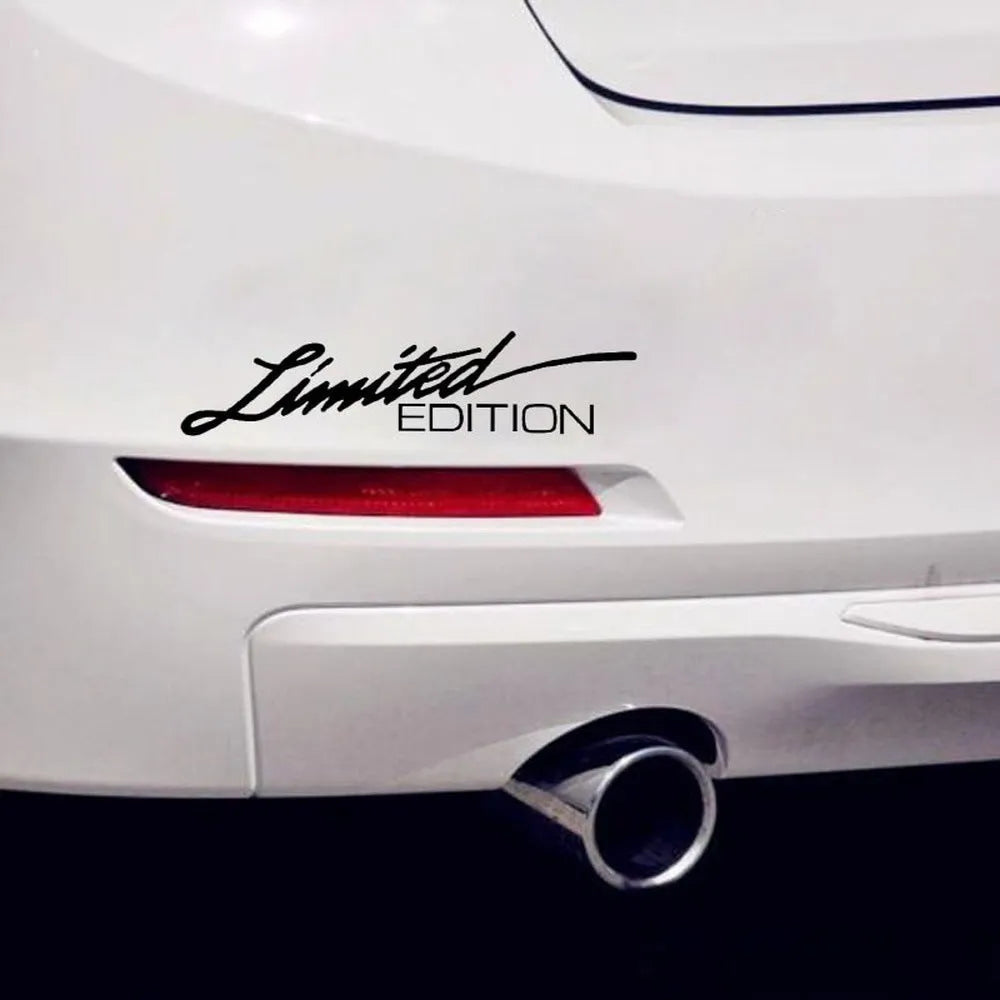 A reflective plastic bumper sticker measuring 16cm by 3.8cm, shown in black, white, and multicolour options.