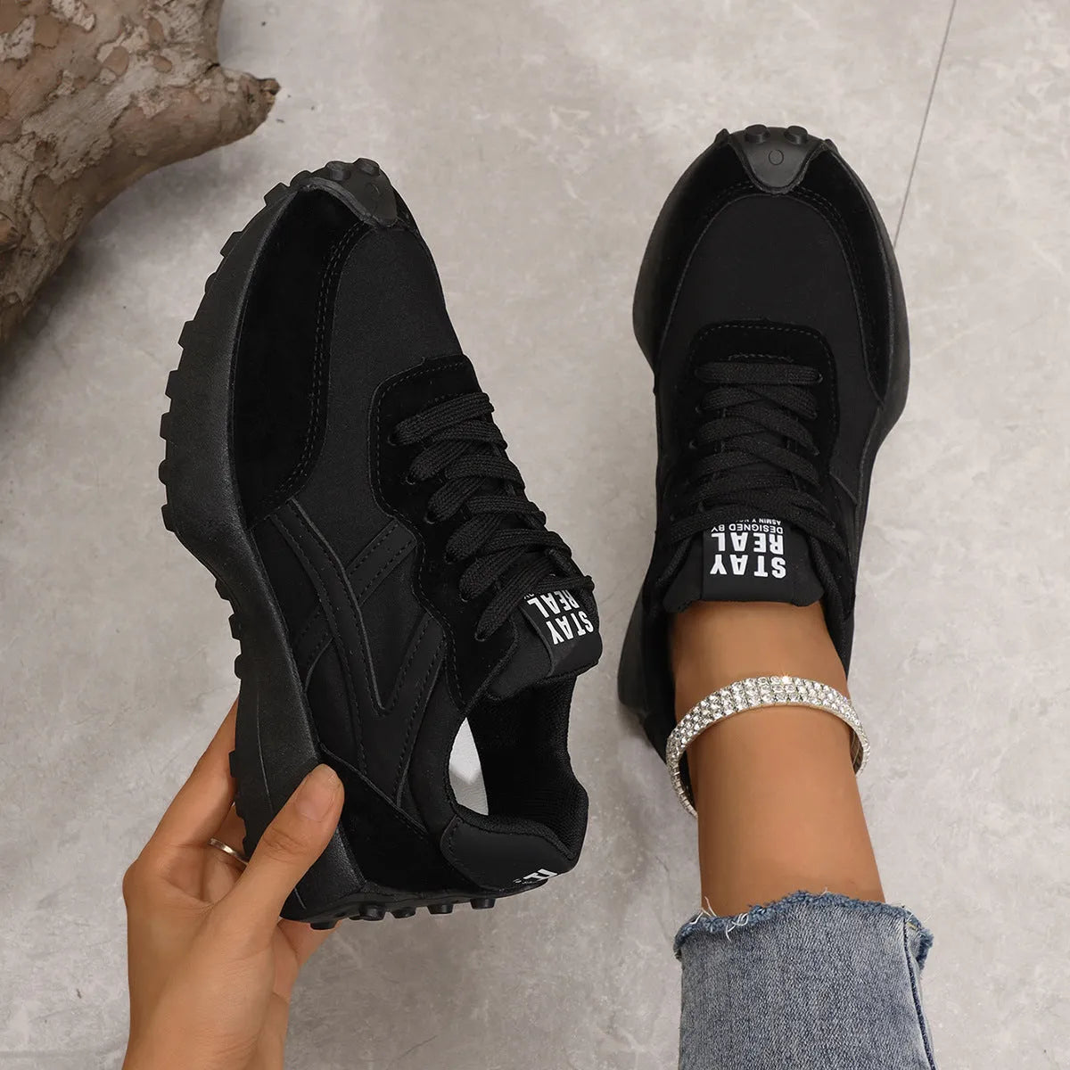 Black mesh sports flat shoes for women with synthetic leather upper and rubber sole, side view