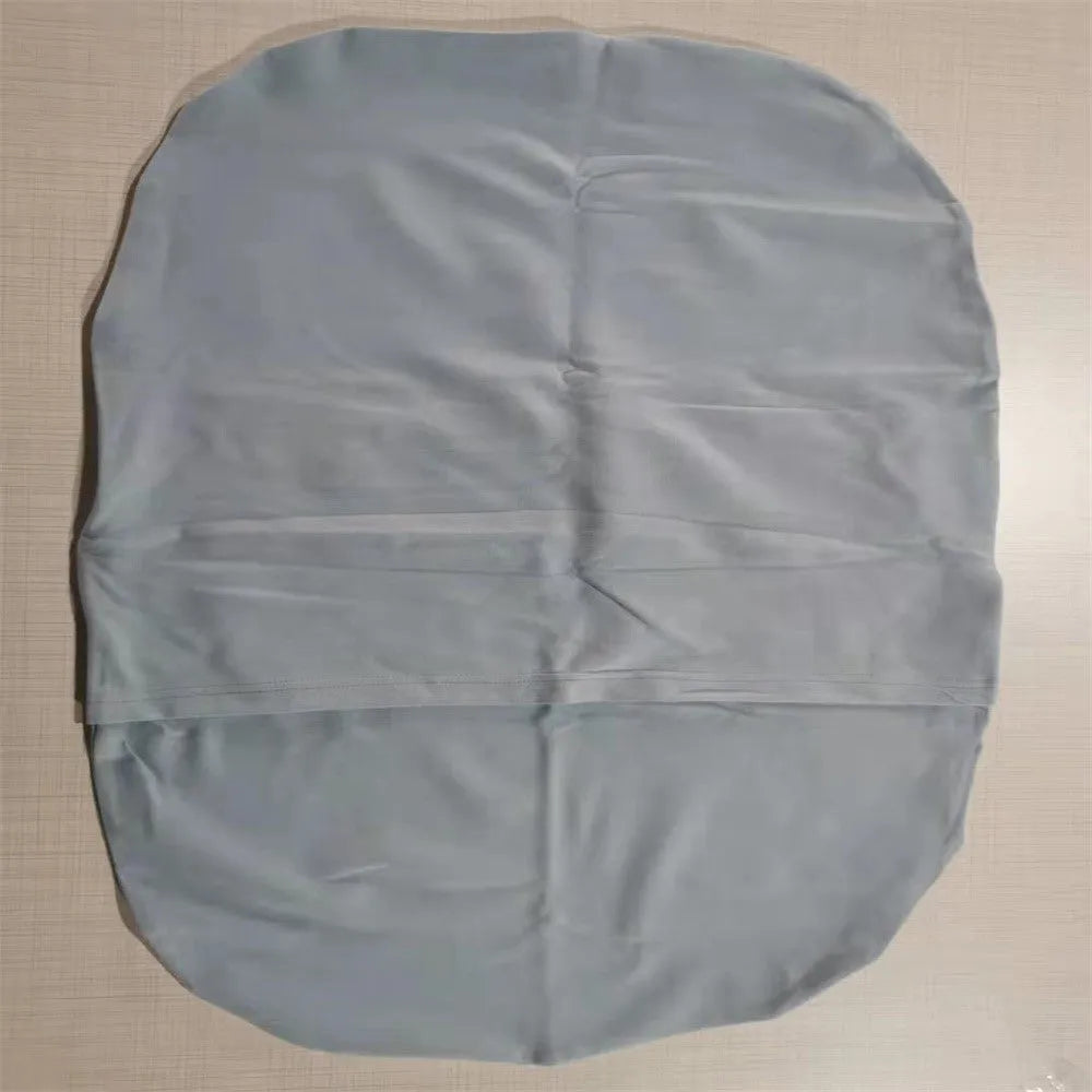 Beige portable baby nest cot crib for infants on a neutral background