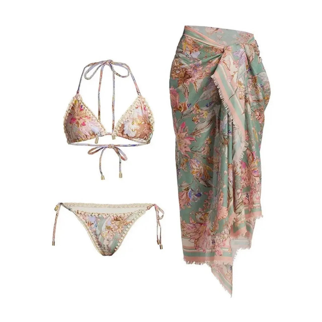Women's creamy-white floral bikini swimsuit set with matching skirt on a beach background.