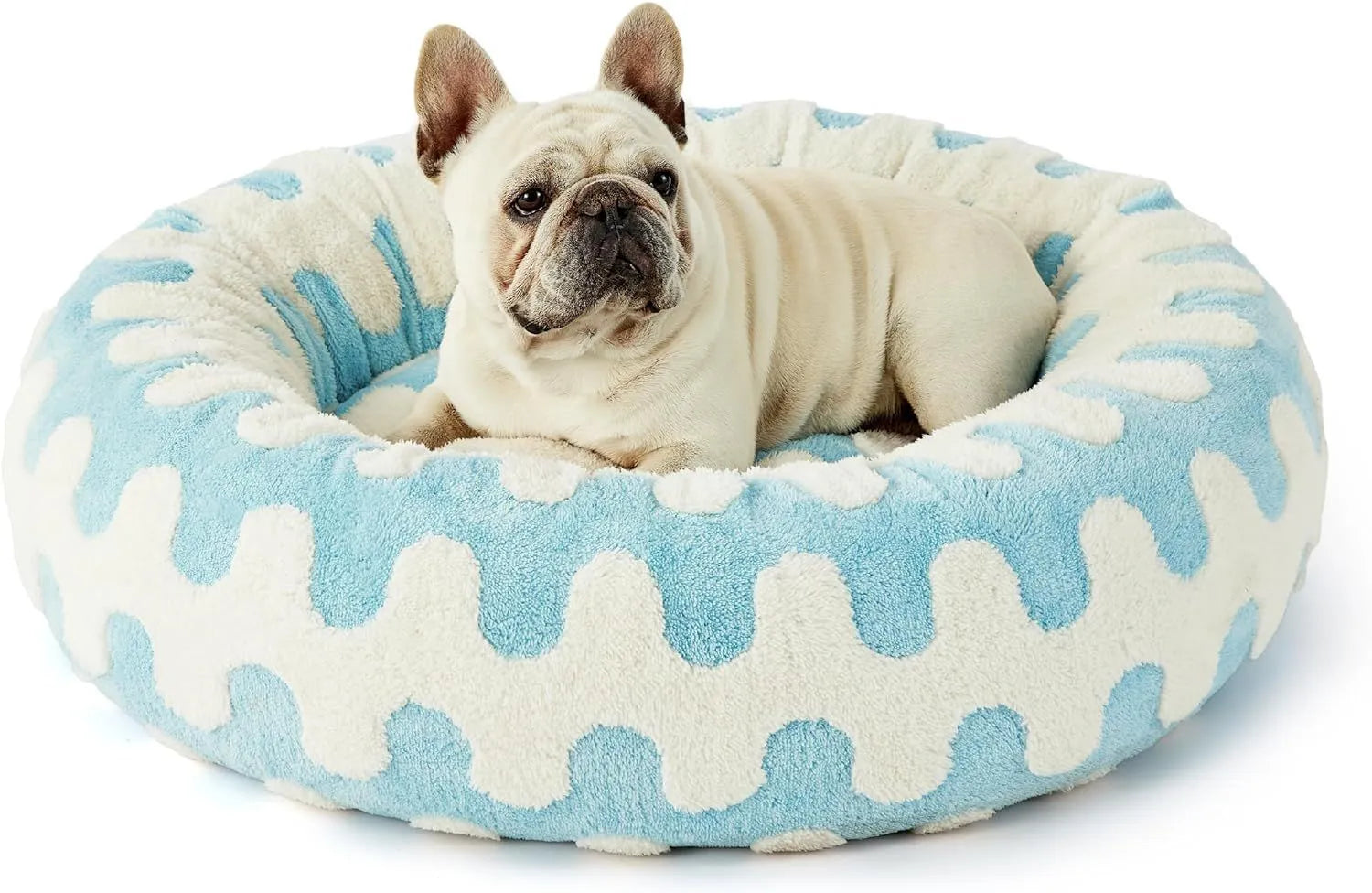 Round blue and white plaid dog bed with a plastic base on a wooden floor.