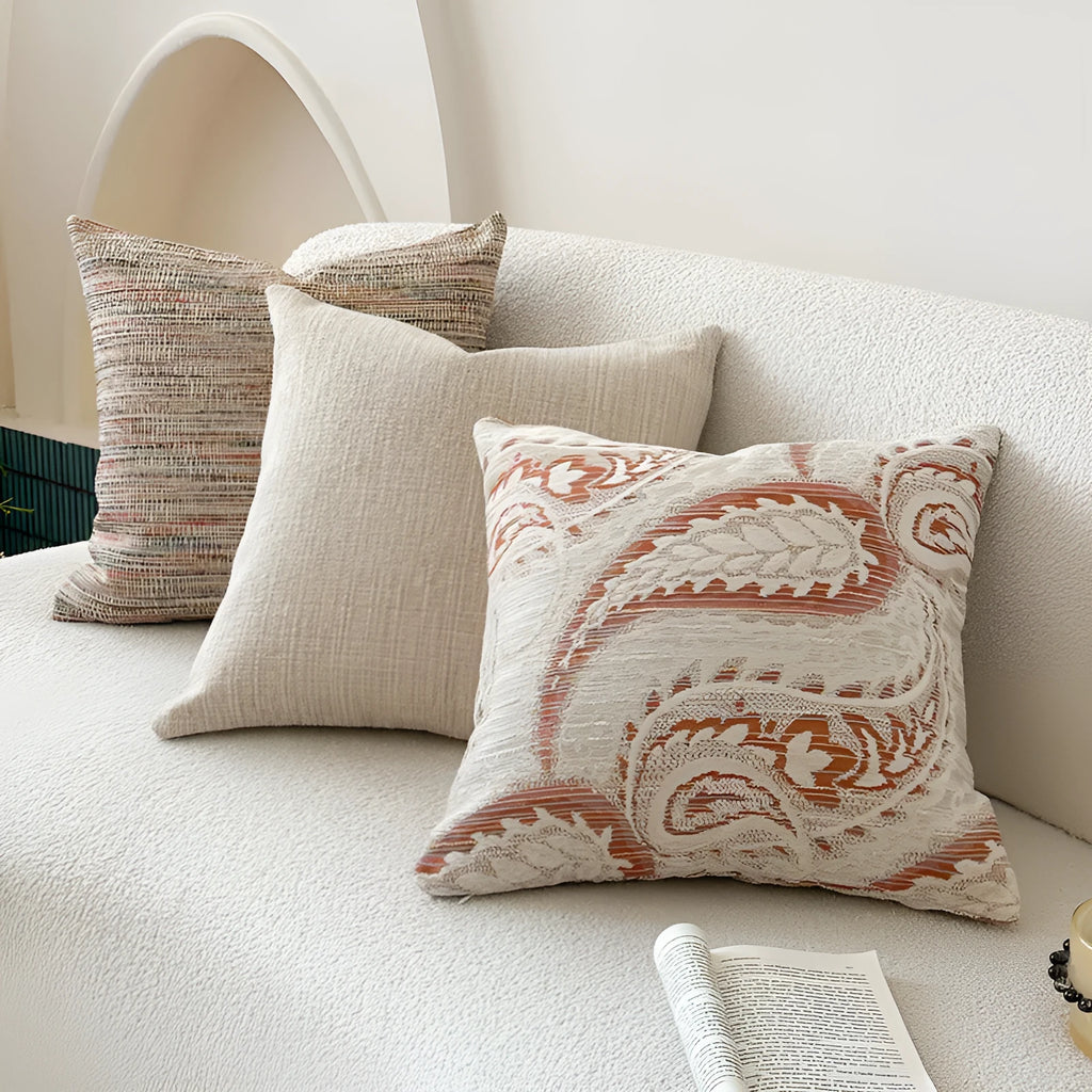 Amber American-style jacquard pillow cover with paisley and flower pattern on a sofa.