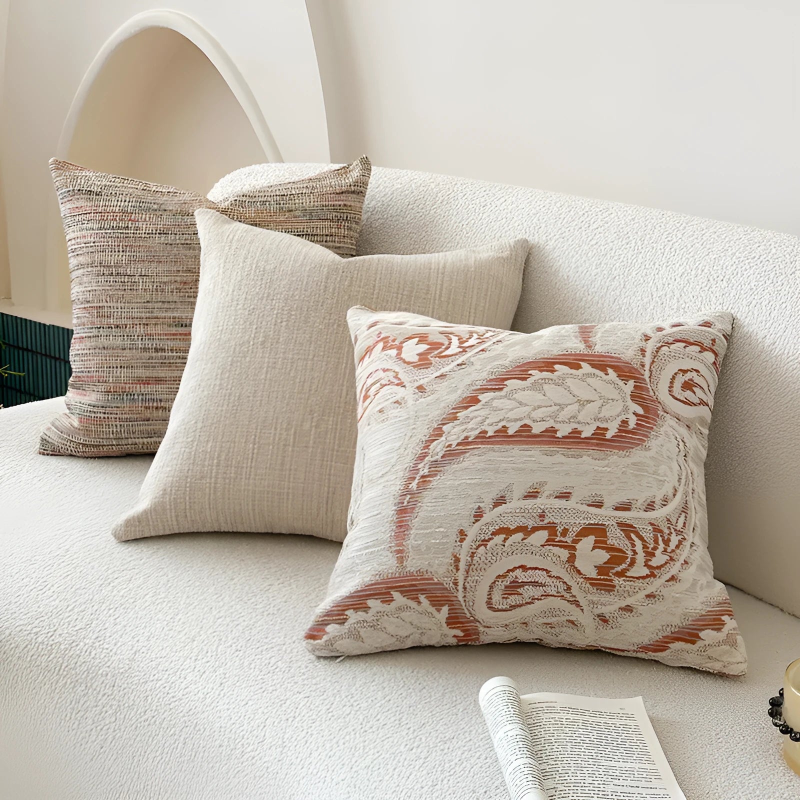 Amber American-style jacquard pillow cover with paisley and flower pattern on a sofa.