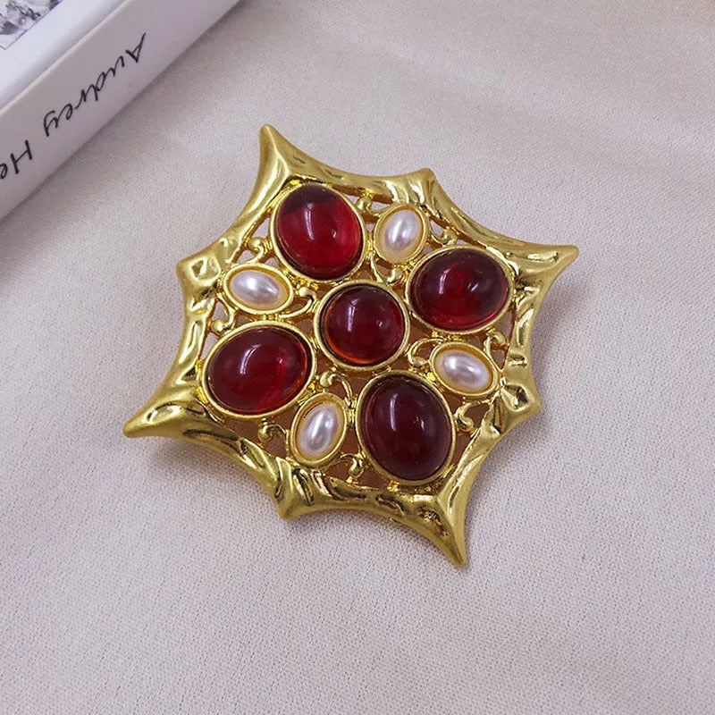 Close-up of a vintage medieval baroque cross brooch in zinc alloy with crystal accents, showing intricate detail.