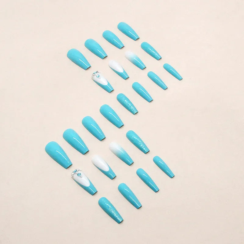 Long ballet shaped false nails in solid blue diamond colour with glitter adhesive glue.