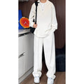 Men's black casual two-piece set with long sleeve polo shirt and trousers on a hanger