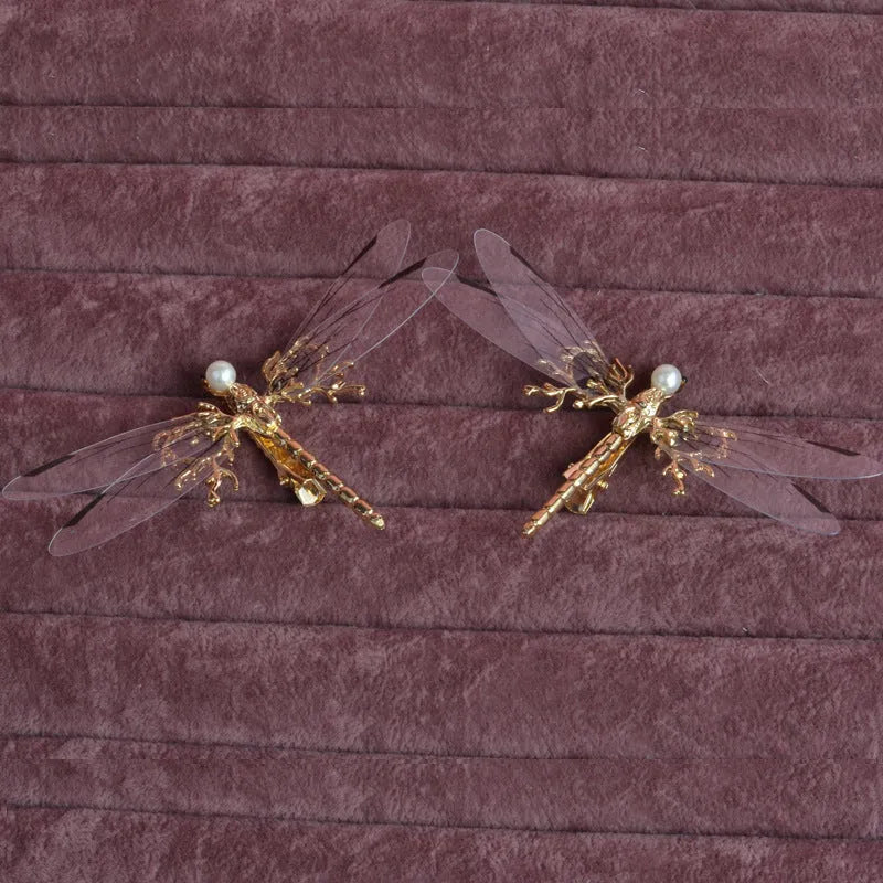 Golden dragonfly-shaped women's headdress with side clip on white background