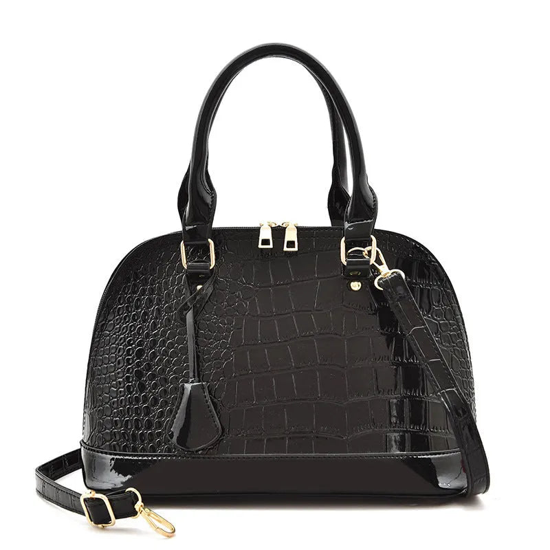 Shiny PU crossbody bag with shell shape, shown in black, red, or brown colour options