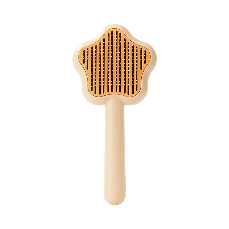 Green self-cleaning pet comb with stainless steel needles on a white background.