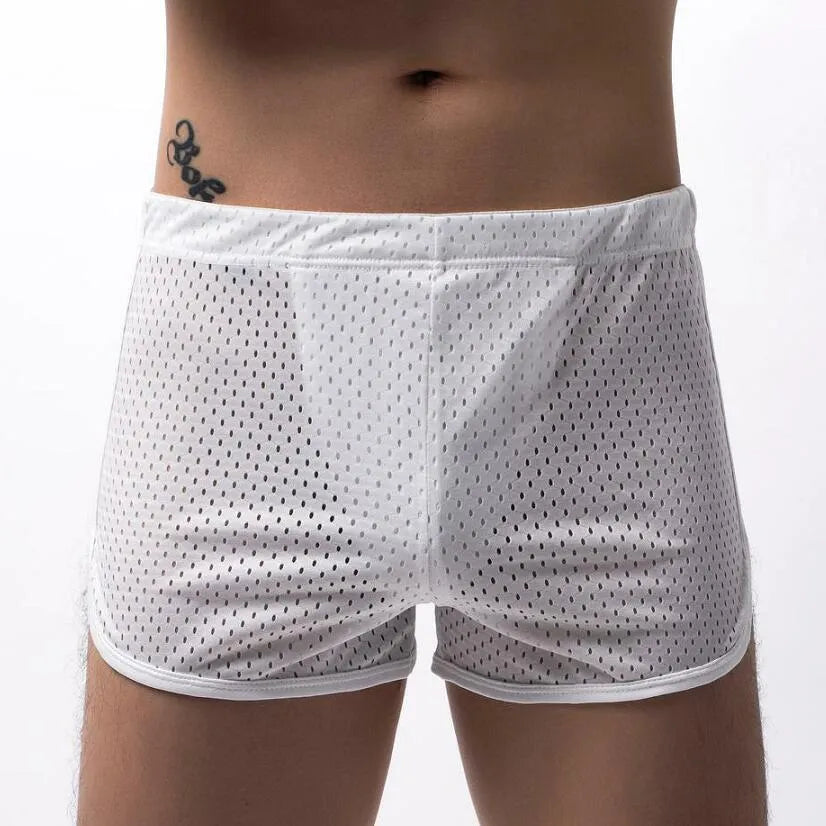 Men's grey cotton blend three-point boxer shorts laid flat, showing mid-waist design and knitted fabric texture.