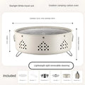 Portable stainless steel barbecue grill with detachable parts on a grassy outdoor surface.
