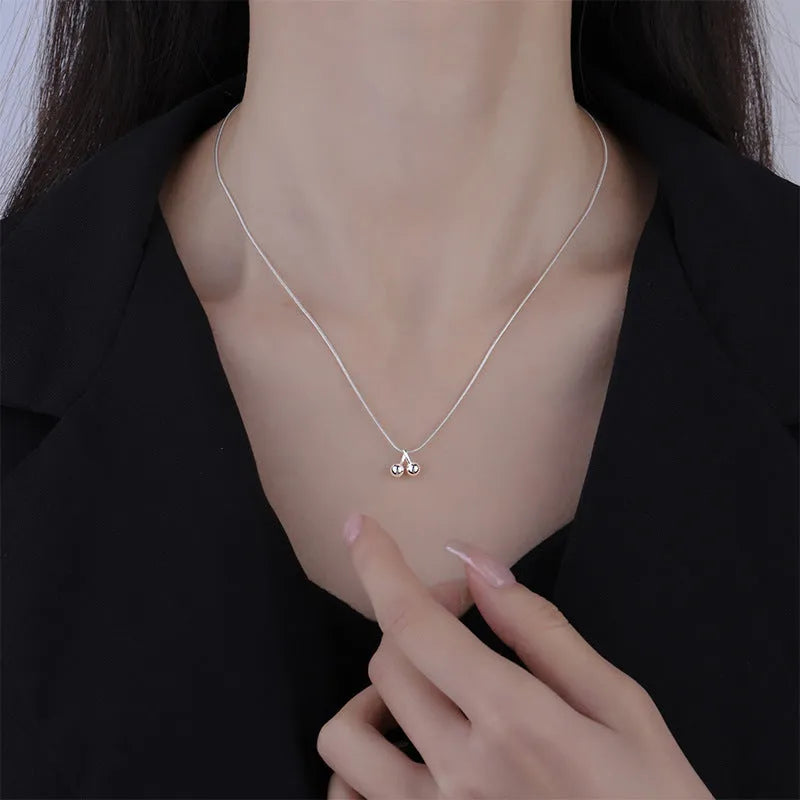 Silver cherry necklace for women on a snake bone chain, adjustable length.