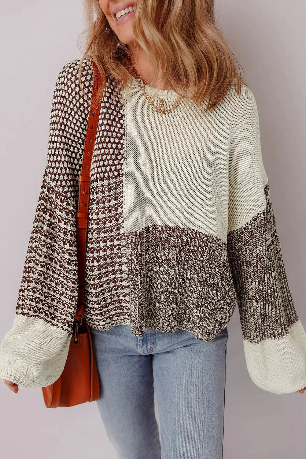 Dark khaki colour-block loose sweater with a back tie and drop shoulders on a hanger.