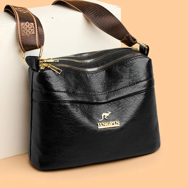 Large capacity multi compartment cross body bag in brown PU with sandwich pocket and sewing thread detail