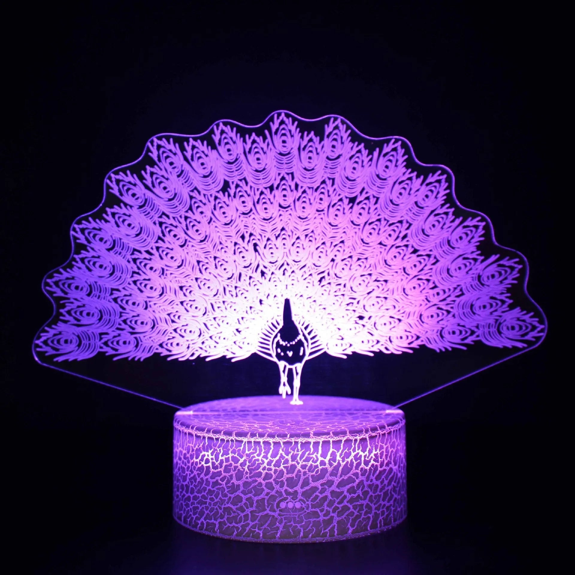 Small blue 3D acrylic USB table lamp with cracked base design lit up on a wooden desk.